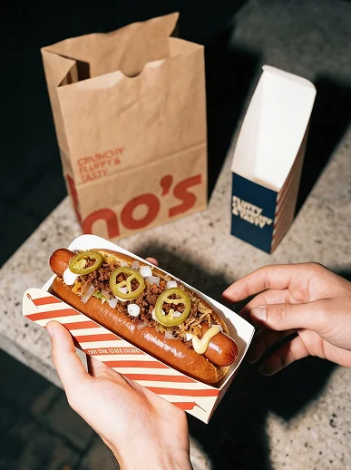 Hand holding hotdog